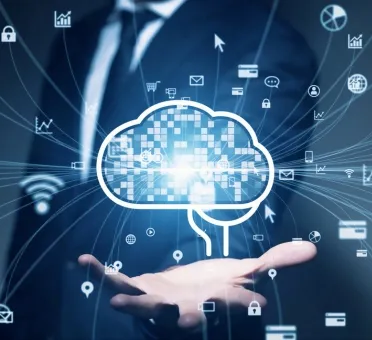 Businessman in suit holding a glowing cloud icon with digital technology and data network symbols around it.
